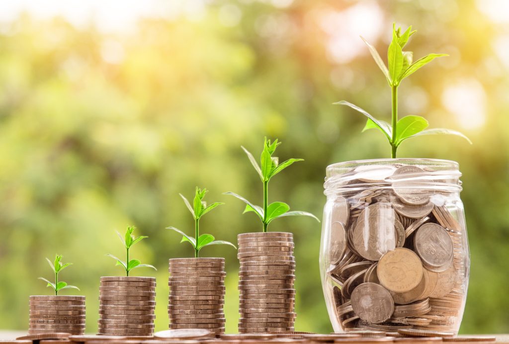 Coins and a growing plant symbolizing an HSA as a retirement tool