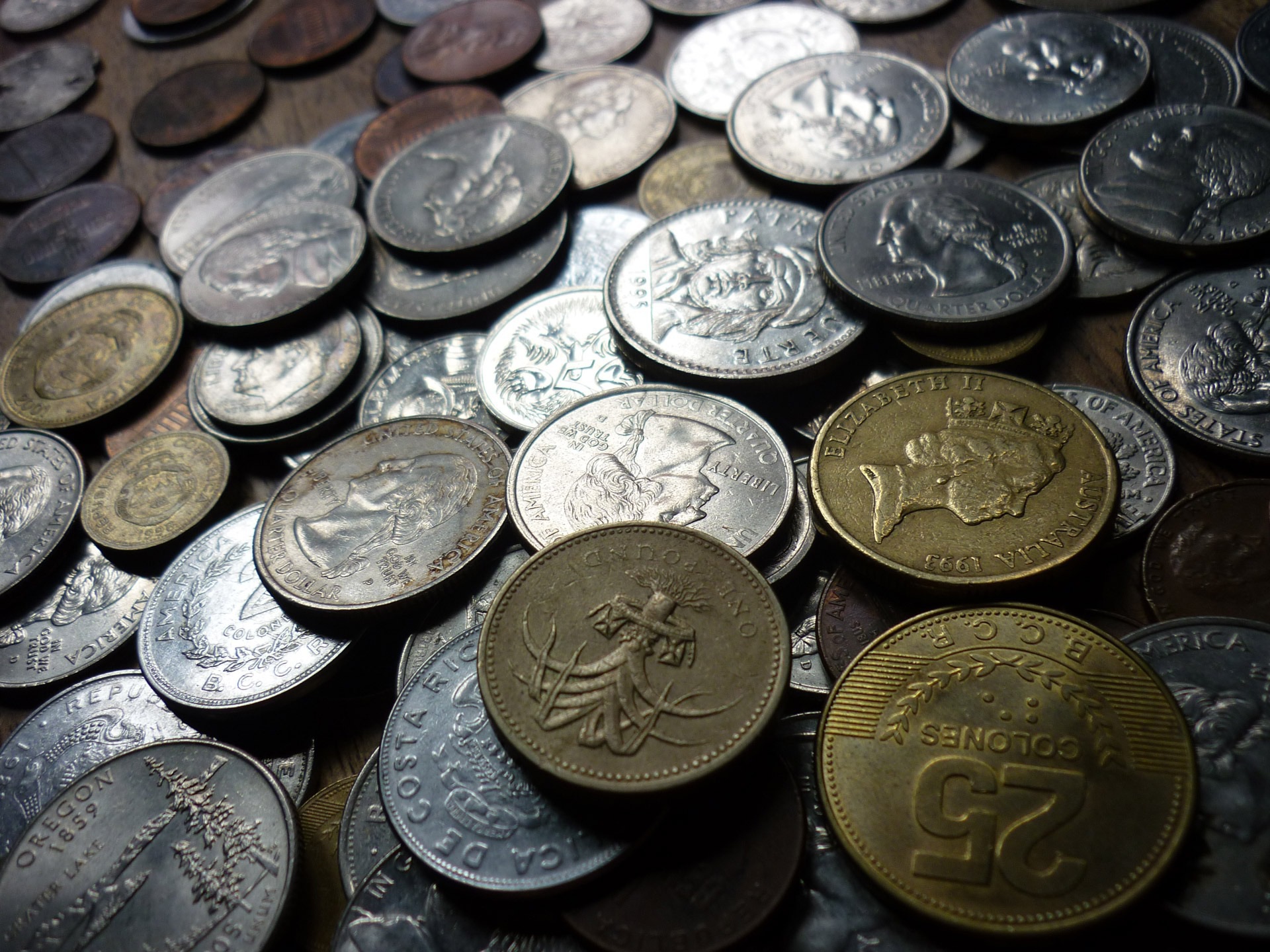 Mixed coins representing a diversified portfolio in index funds vs. ETFs