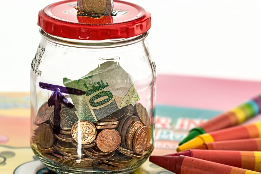 Glass jar of coins representing an emergency fund savings cushion