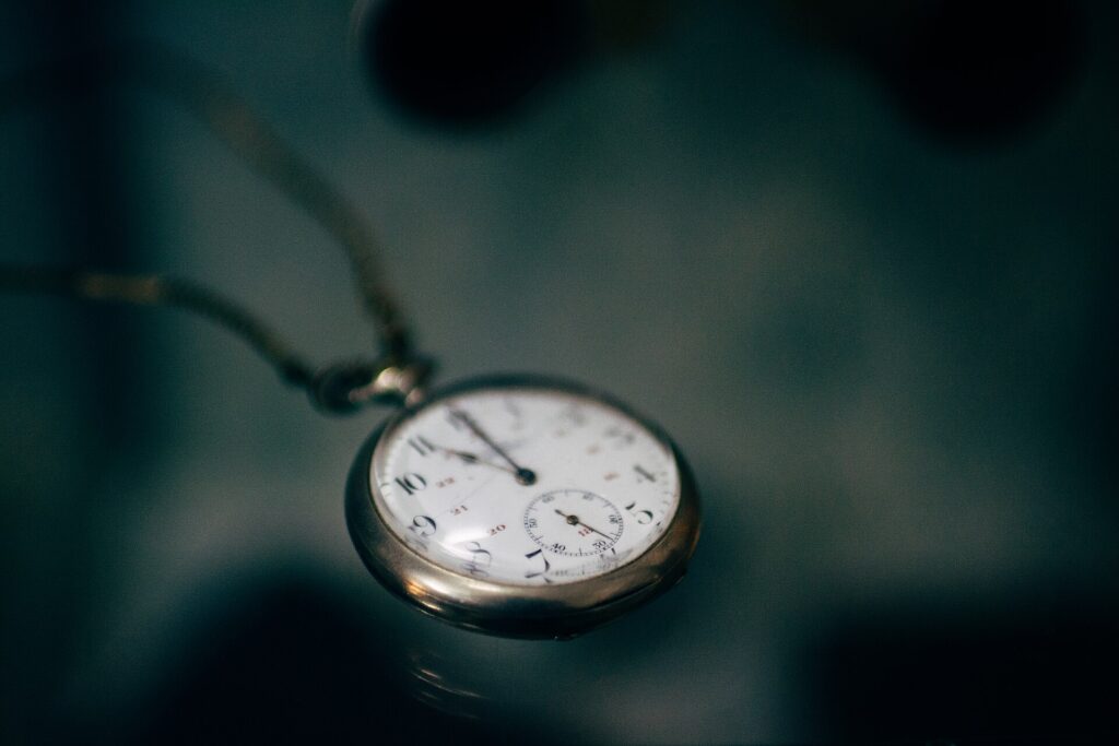 Old pocket watch representing the coverage period in term vs whole life insurance