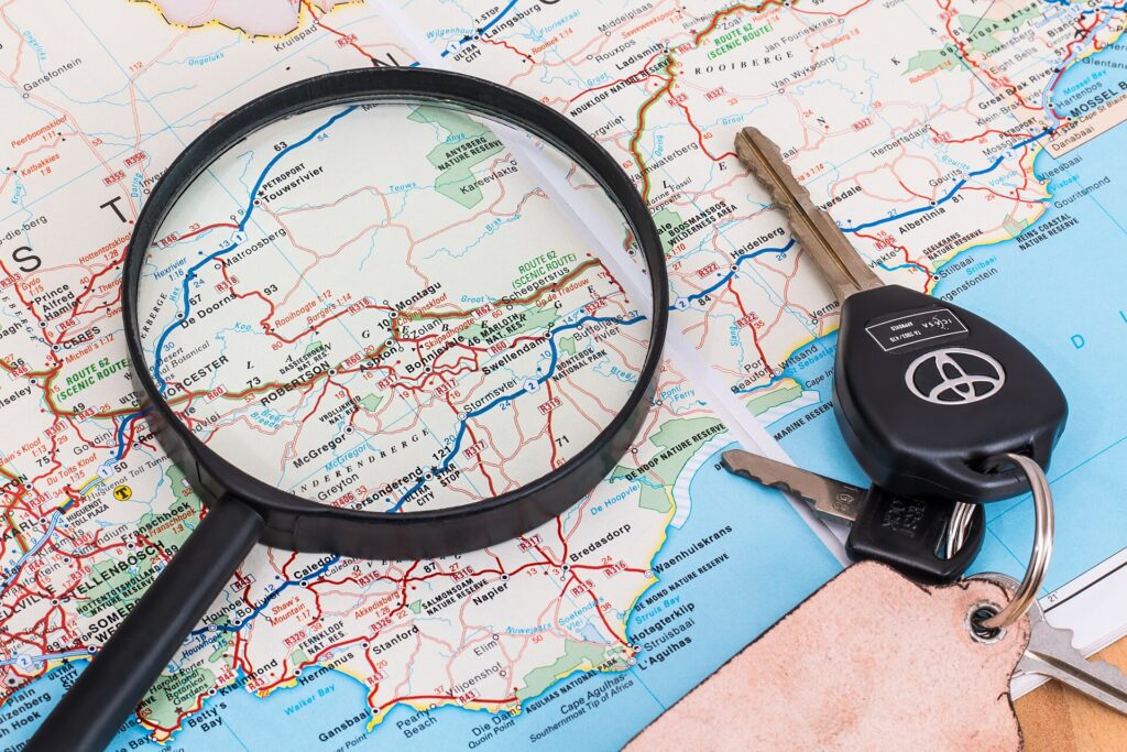 Car keys on a road map representing the total cost of car ownership